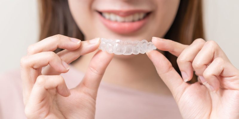 Dental,Invisible,Braces,,Beautiful,Smiling,Asian,Young,Woman,Holding,Invisalign